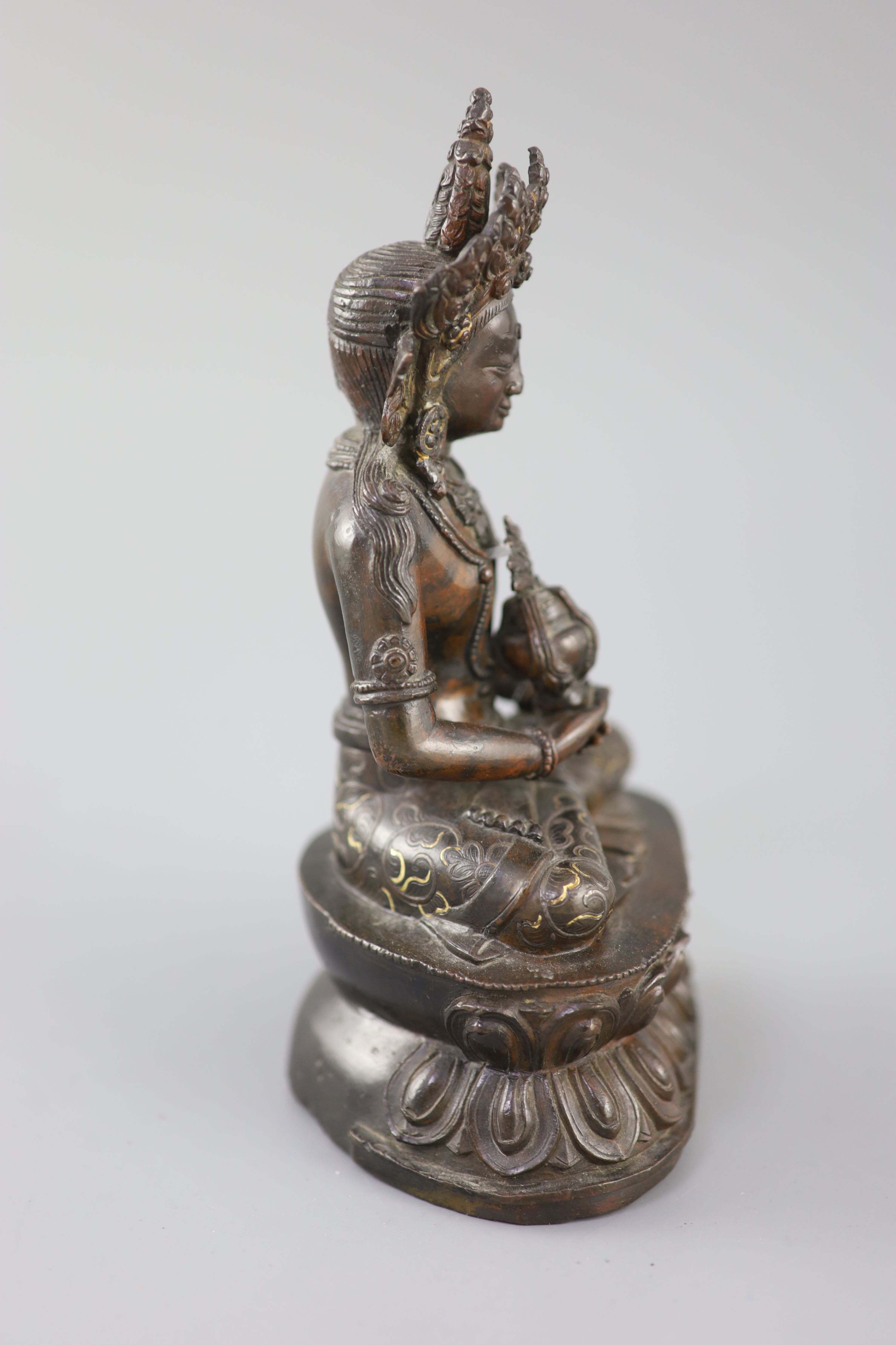 A Tibetan silver and gold inlaid copper alloy figure of Amitayus/Amitabha, c.15th century, 20.5cm high
